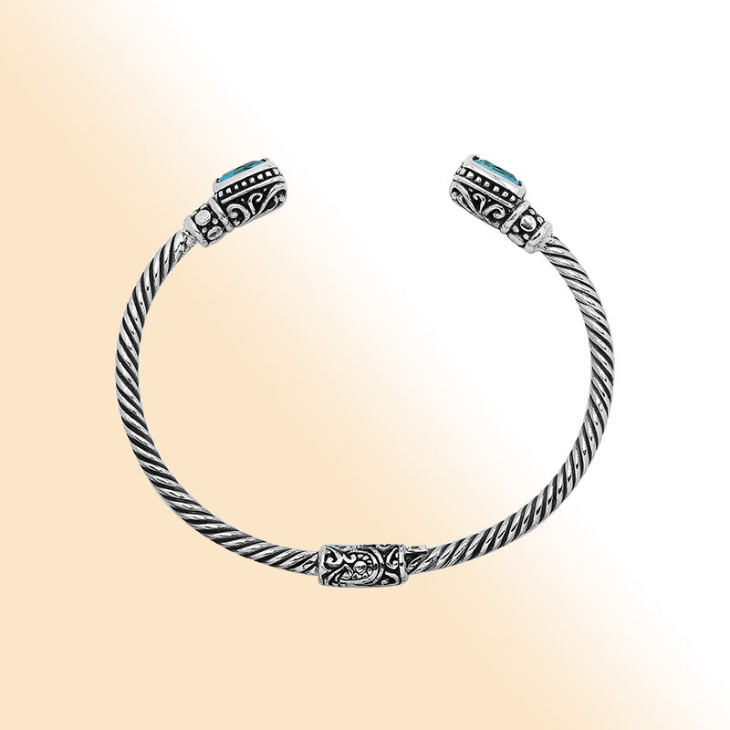 Sterling silver Balinese cuff bangle with Blue Topaz Quartz accents and intricate scroll design.