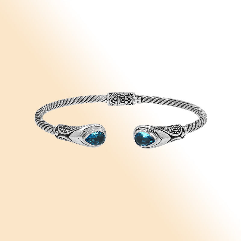 Sterling silver Balinese cuff bangle with Blue Topaz Quartz accents and ornate scroll design.