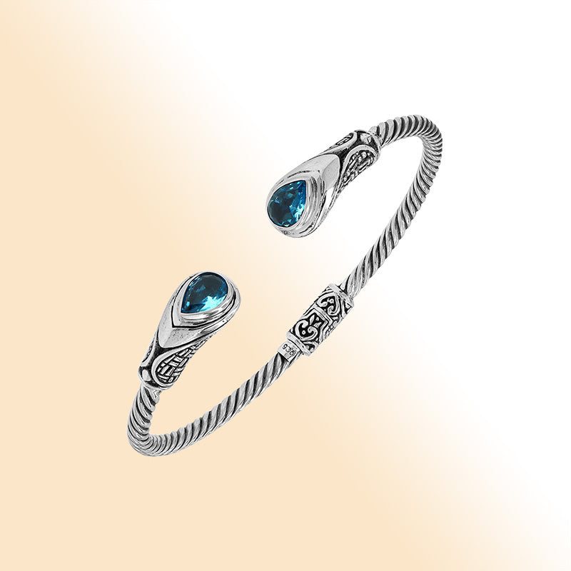 Sterling silver Balinese cuff bangle with Blue Topaz Quartz accents and ornate scroll design.