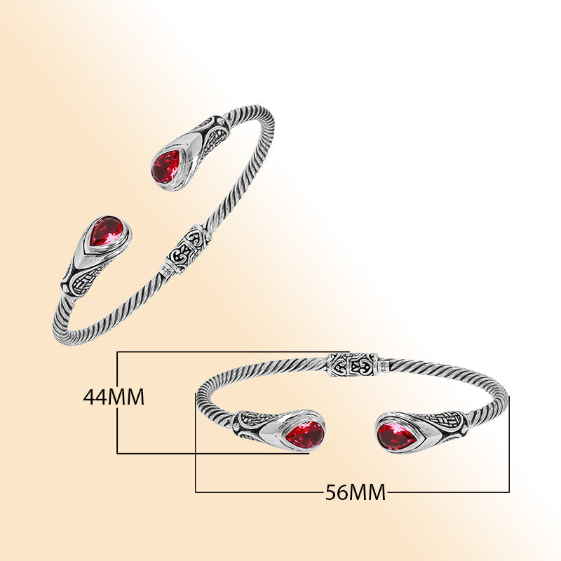 Sterling silver Balinese cuff bangle with Garnet Quartz accents and ornate scroll design.