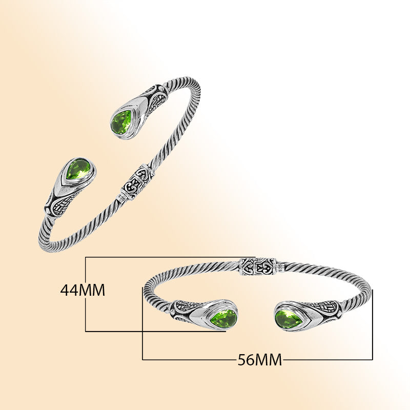 Sterling silver Balinese cuff bangle with Peridot Quartz accents and ornate scroll design.