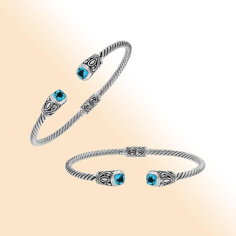 Sterling silver Balinese cuff bangle with Blue Topaz Quartz accents and ornate scroll design.