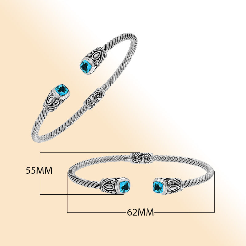 Sterling silver Balinese cuff bangle with Blue Topaz Quartz accents and ornate scroll design.