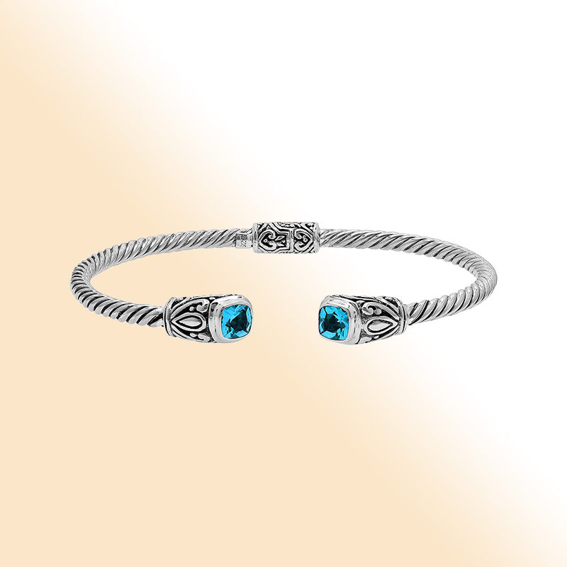 Sterling silver Balinese cuff bangle with Blue Topaz Quartz accents and ornate scroll design.