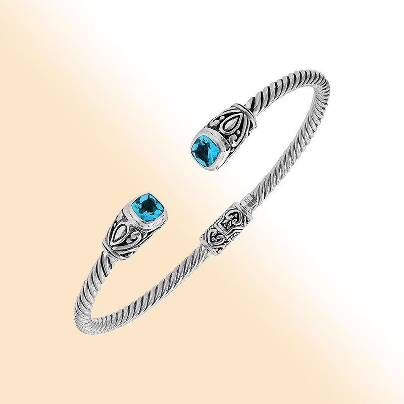 Sterling silver Balinese cuff bangle with Blue Topaz Quartz accents and ornate scroll design.