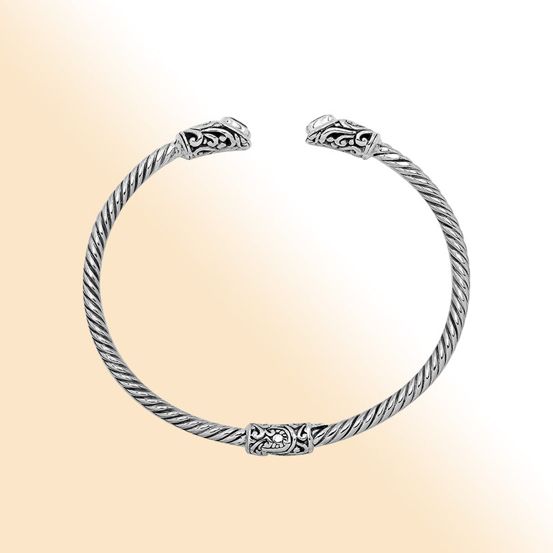 Sterling silver Balinese cuff bangle with Blue Topaz Quartz accents and ornate scroll design.