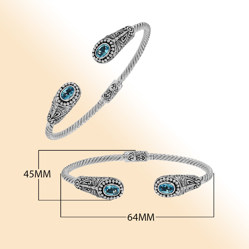 Sterling silver Balinese cuff bangle with Blue Topaz Quartz accents and ornate scroll design.
