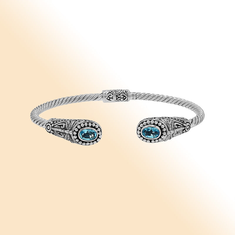 Sterling silver Balinese cuff bangle with Blue Topaz Quartz accents and ornate scroll design.