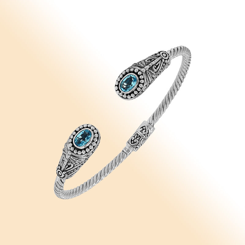 Sterling silver Balinese cuff bangle with Blue Topaz Quartz accents and ornate scroll design.