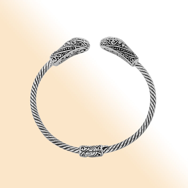 Sterling silver Balinese cuff bangle with Blue Topaz Quartz accents and ornate scroll design.