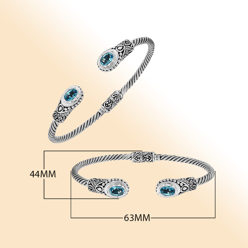 Sterling silver Balinese bangle with Blue Topaz Quartz stones and beaded scroll design.