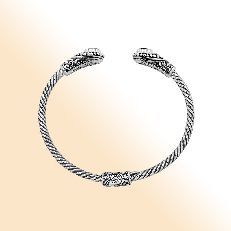 Sterling silver Balinese bangle with Blue Topaz Quartz stones and beaded scroll design.