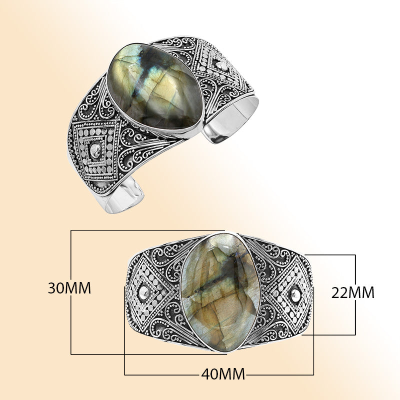 Sterling silver Balinese statement bangle with Labradorite centerpiece and intricate bead scrollwork.