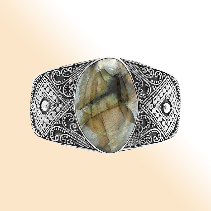 Sterling silver Balinese statement bangle with Labradorite centerpiece and intricate bead scrollwork.