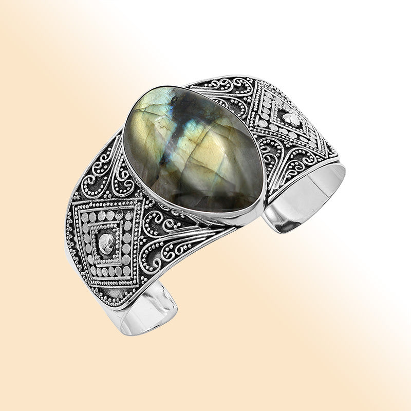 Sterling silver Balinese statement bangle with Labradorite centerpiece and intricate bead scrollwork.