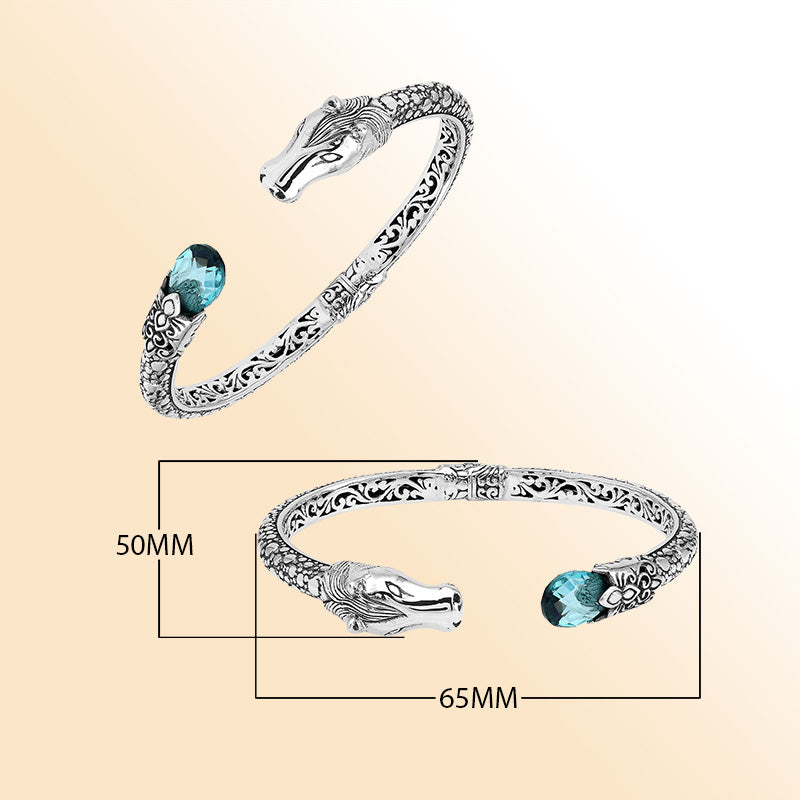Handcrafted sterling silver dragon head bangle with Blue Topaz Quartz from Bali featuring detailed filigree and antique finish.