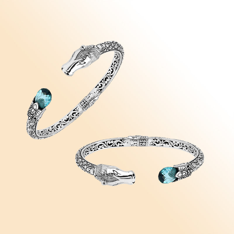 Handcrafted sterling silver dragon head bangle with Blue Topaz Quartz from Bali featuring detailed filigree and antique finish.