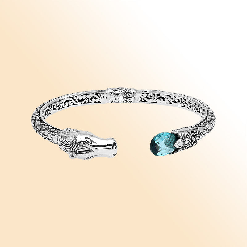 Handcrafted sterling silver dragon head bangle with Blue Topaz Quartz from Bali featuring detailed filigree and antique finish.