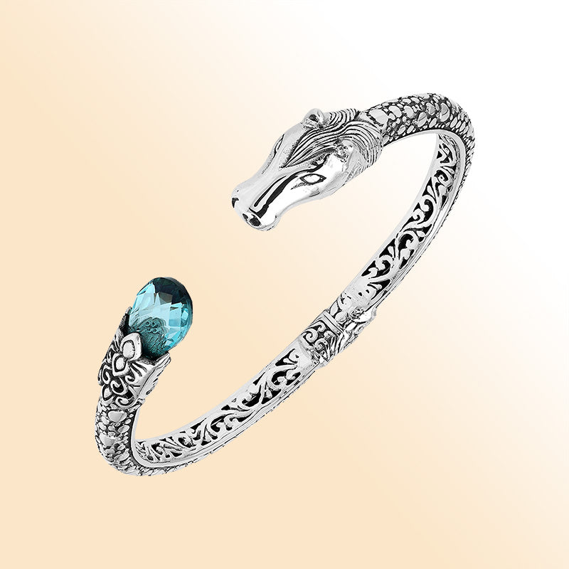 Handcrafted sterling silver dragon head bangle with Blue Topaz Quartz from Bali featuring detailed filigree and antique finish.