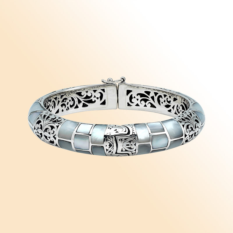 Handcrafted sterling silver mother of pearl inlay hinged bangle with filigree accents made in Bali.