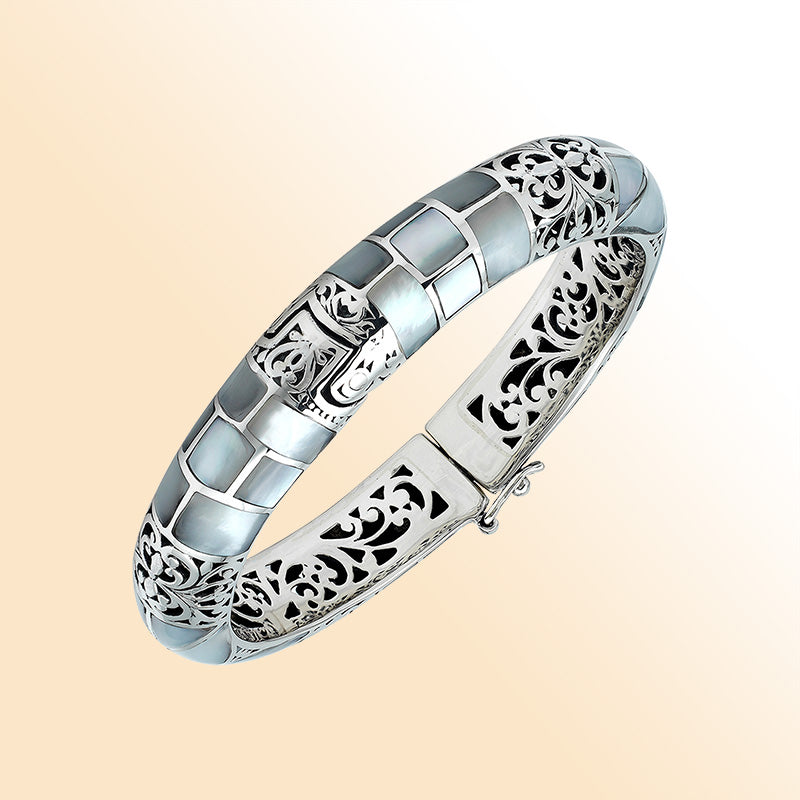 Handcrafted sterling silver mother of pearl inlay hinged bangle with filigree accents made in Bali.