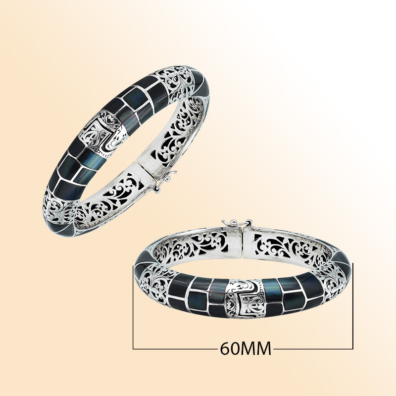 Handcrafted sterling silver bangle with black shell mosaic inlay and intricate filigree pattern from Bali.