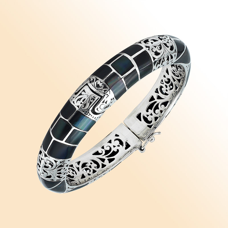 Handcrafted sterling silver bangle with black shell mosaic inlay and intricate filigree pattern from Bali.