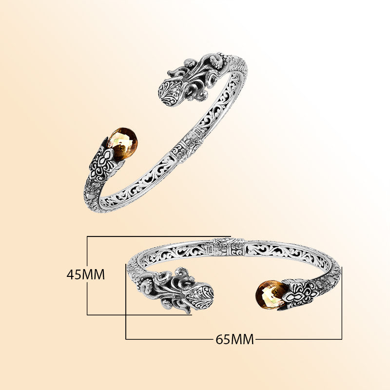 A handcrafted sterling silver octopus bangle featuring citrine quartz, ornate Balinese tentacle carvings, oxidized detailing, and a smooth hinge lock for stylish luxury wear.