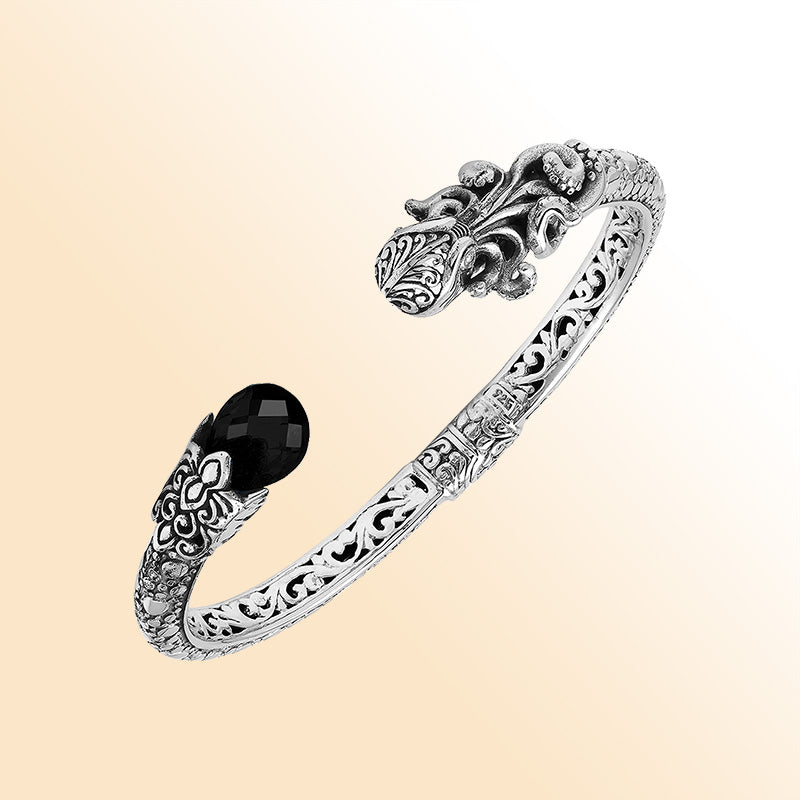 Handcrafted sterling silver dragon head cuff with black onyx ends and floral carvings made in Bali.