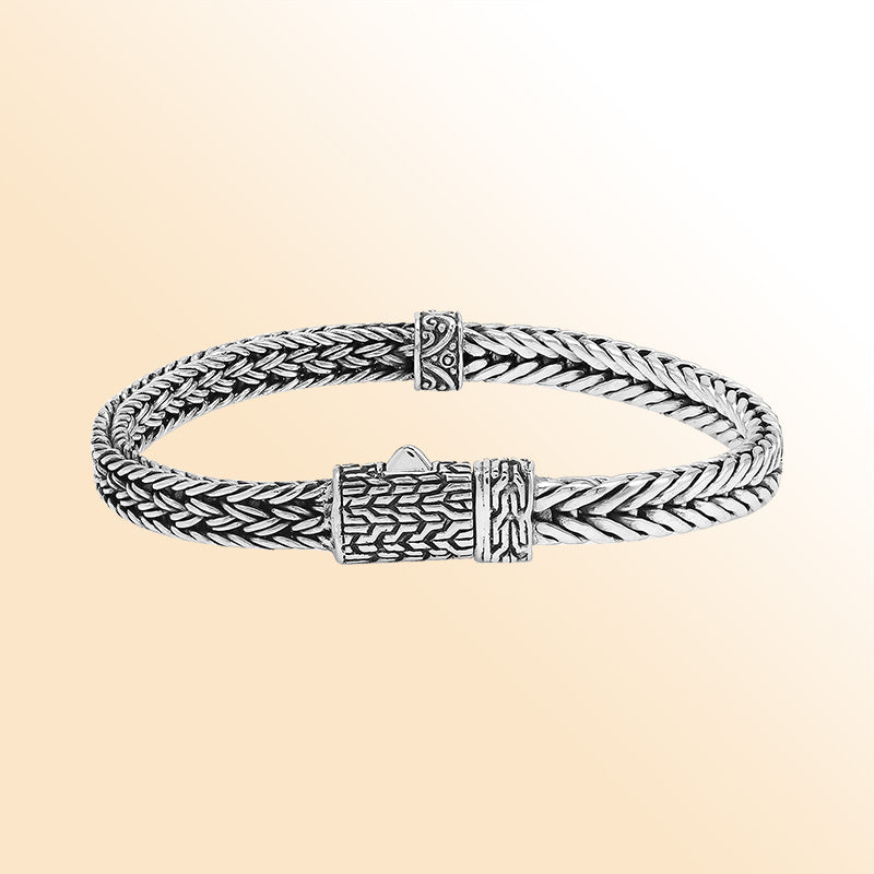 Elegant sterling silver woven chain bracelet with artistic detailing and secure push clasp, polished to perfection for modern everyday style and timeless sophistication.