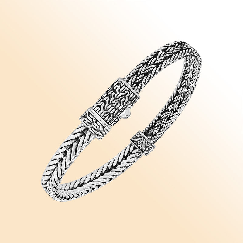 Elegant sterling silver woven chain bracelet with artistic detailing and secure push clasp, polished to perfection for modern everyday style and timeless sophistication.