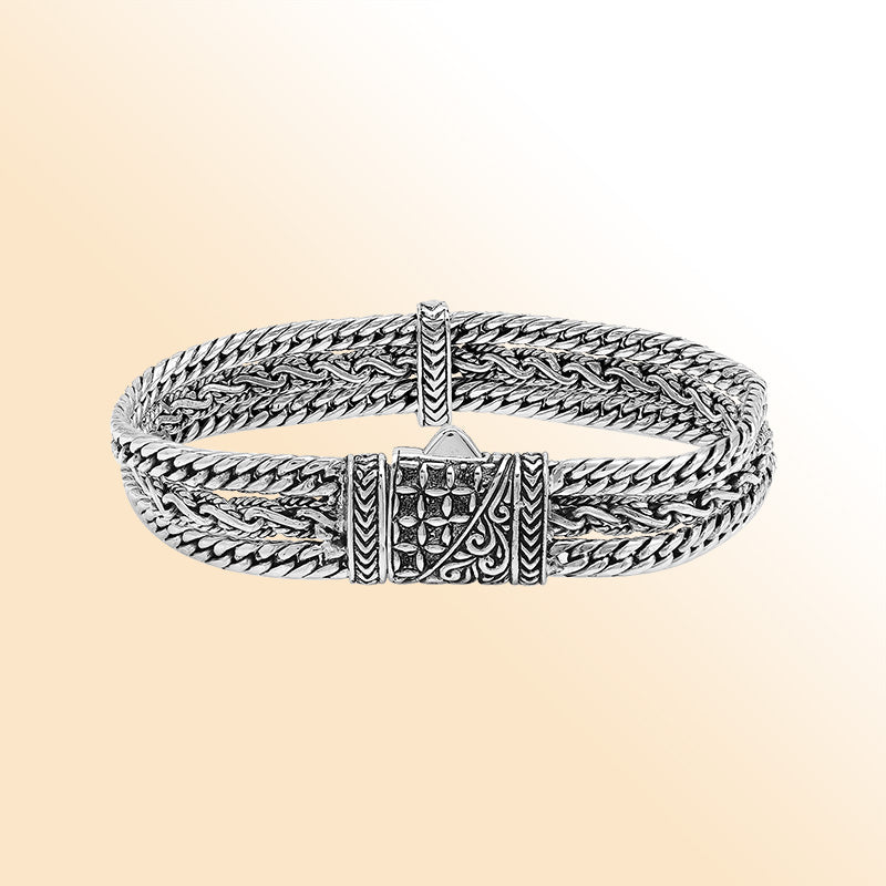 A handcrafted sterling silver woven chain bracelet featuring multi-strand Balinese detailing, oxidized textures, and a secure push clasp designed for stylish everyday wear.