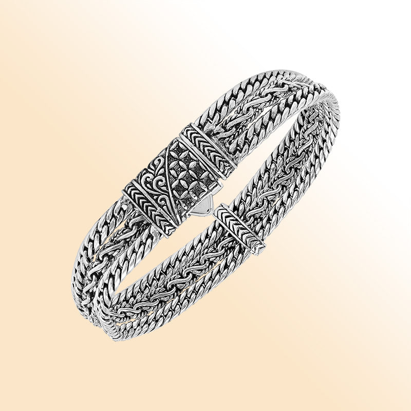 A handcrafted sterling silver woven chain bracelet featuring multi-strand Balinese detailing, oxidized textures, and a secure push clasp designed for stylish everyday wear.