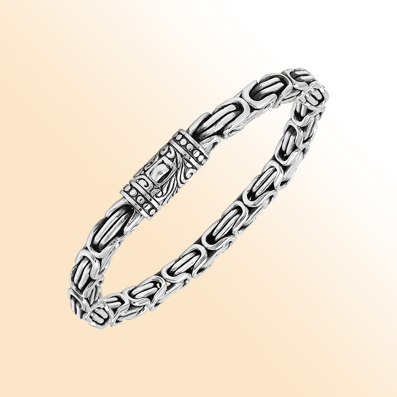 A handcrafted sterling silver bracelet featuring thick Balinese chain links, oxidized highlights, artistic metalwork, and a strong push clasp perfect for everyday luxury wear.