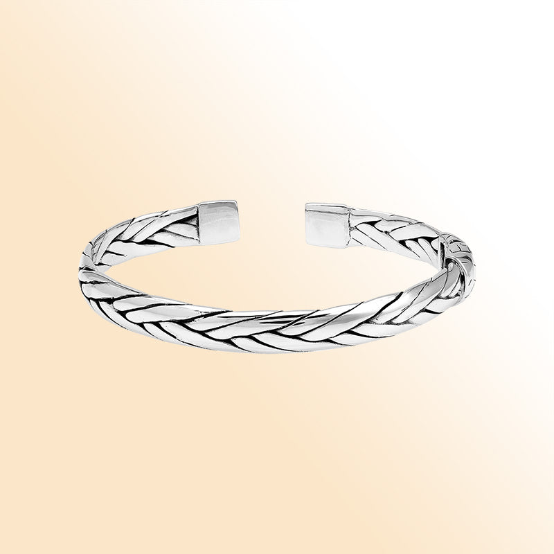 A handcrafted sterling silver small bangle featuring woven Balinese textures, polished finishing, and a strong hinge lock designed for stylish everyday wear.