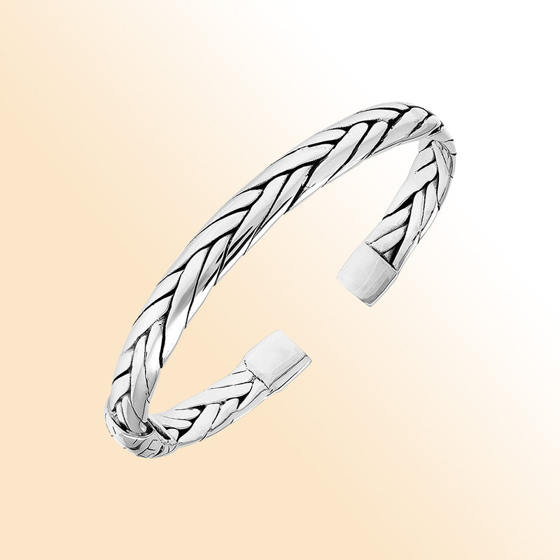 A handcrafted sterling silver small bangle featuring woven Balinese textures, polished finishing, and a strong hinge lock designed for stylish everyday wear.