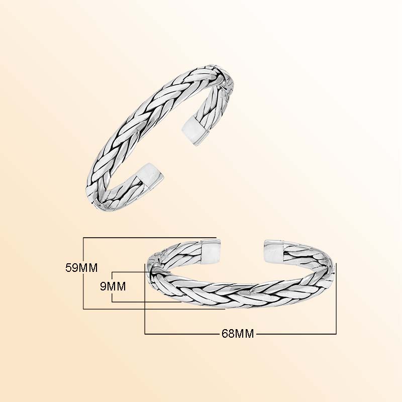 A handcrafted sterling silver large bangle featuring wide woven patterns, polished surfaces, and a secure hinge lock, designed for elegant everyday or statement wear.