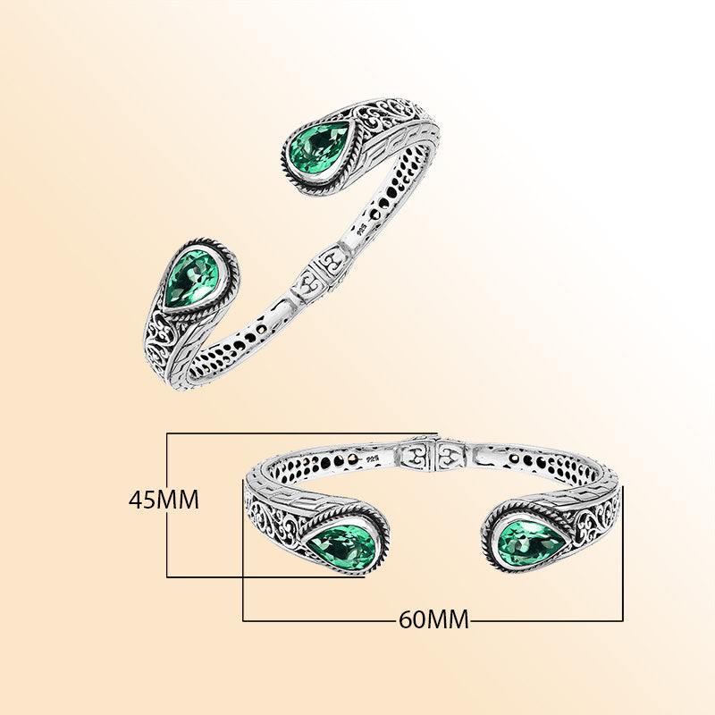 Sterling silver hinge-lock cuff bangle with green quartz teardrops and Balinese carved detailing.