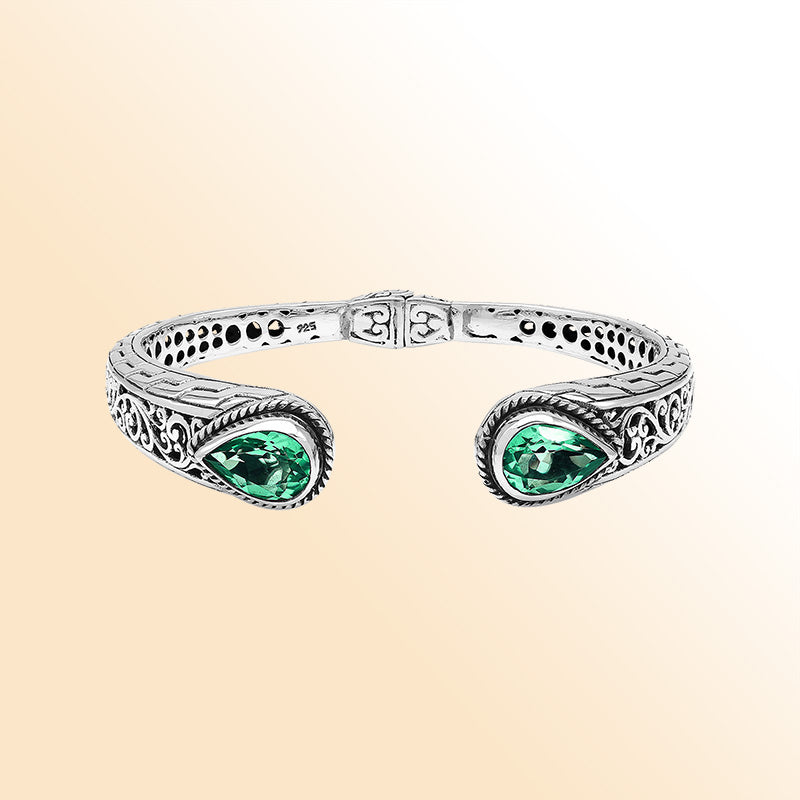 Sterling silver hinge-lock cuff bangle with green quartz teardrops and Balinese carved detailing.