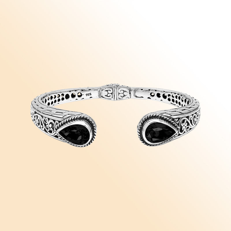 Sterling silver hinge-lock cuff bangle with Black Onyx teardrops and ornate Balinese carvings.