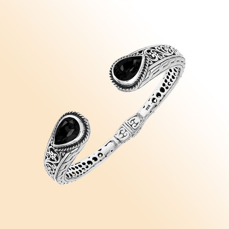Sterling silver hinge-lock cuff bangle with Black Onyx teardrops and ornate Balinese carvings.