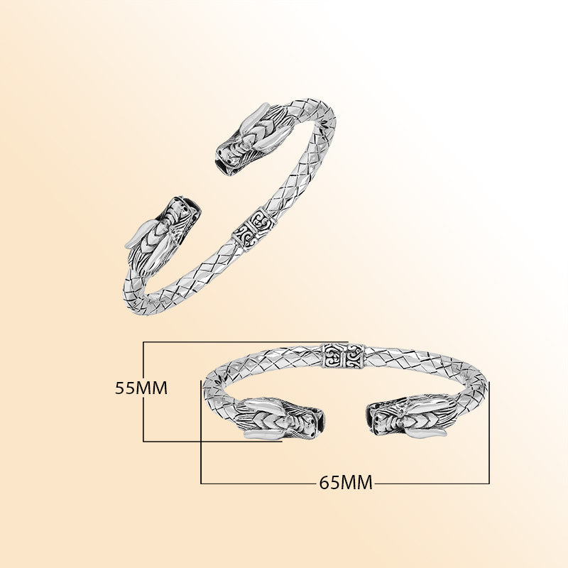 Sterling silver dragon head bangle with intricate carvings, textured detailing, and a comfortable hinge-lock system, offering symbolic strength and artistic Balinese craftsmanship for daily wear.