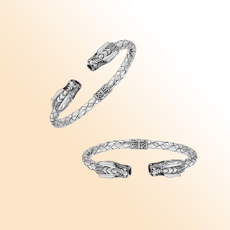 Sterling silver dragon head bangle with intricate carvings, textured detailing, and a comfortable hinge-lock system, offering symbolic strength and artistic Balinese craftsmanship for daily wear.