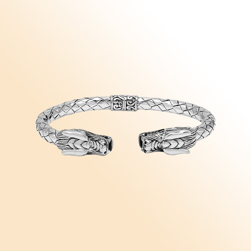 Sterling silver dragon head bangle with intricate carvings, textured detailing, and a comfortable hinge-lock system, offering symbolic strength and artistic Balinese craftsmanship for daily wear.