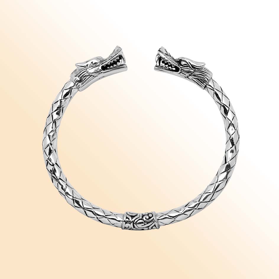Sterling silver dragon head bangle with intricate carvings, textured detailing, and a comfortable hinge-lock system, offering symbolic strength and artistic Balinese craftsmanship for daily wear.