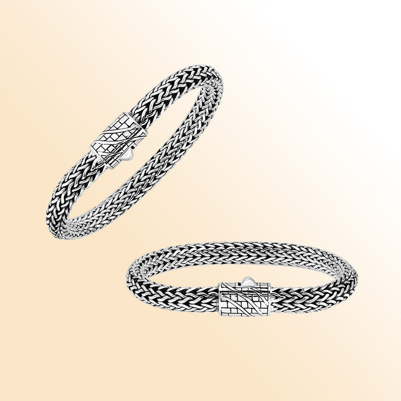 A handcrafted sterling silver wide woven bracelet featuring an engraved push clasp, polished and oxidized detailing, and bold woven styling ideal for modern everyday elegance.