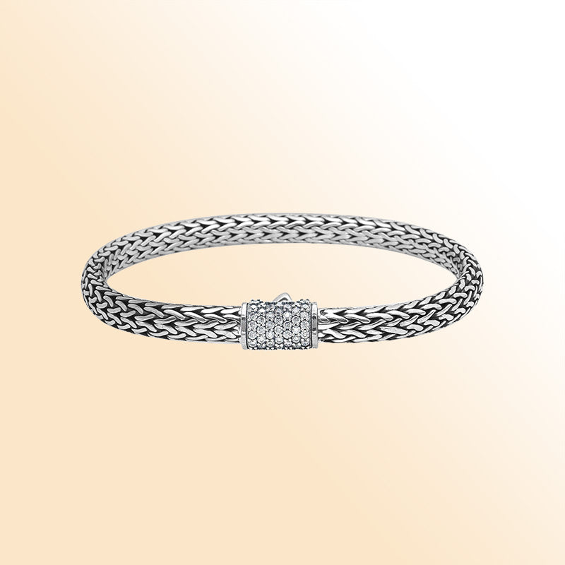 A handcrafted sterling silver elegant woven bracelet featuring a radiant CVD Diamond-studded push clasp, polished–oxidized detailing, and modern luxury styling ideal for everyday wear.