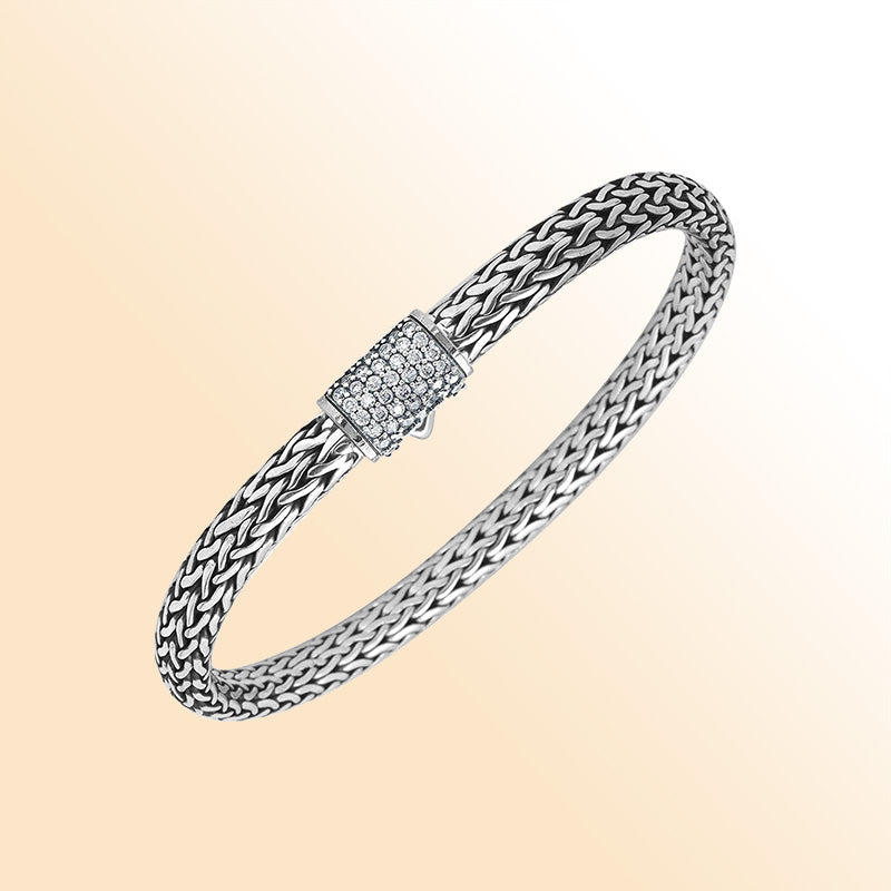 A handcrafted sterling silver elegant woven bracelet featuring a radiant CVD Diamond-studded push clasp, polished–oxidized detailing, and modern luxury styling ideal for everyday wear.
