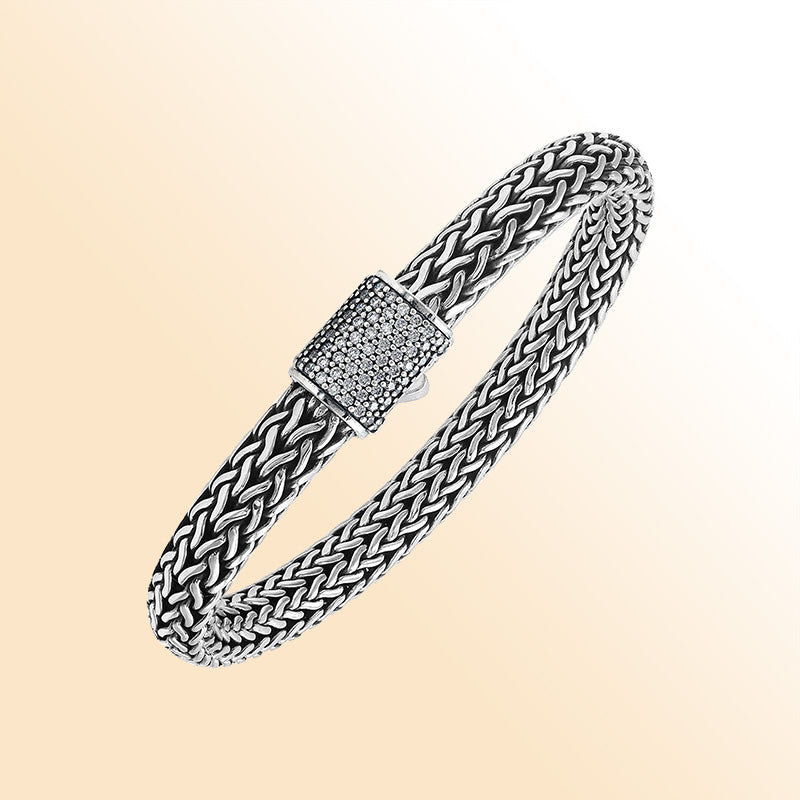 A handcrafted sterling silver radiant woven bracelet featuring a sparkling CVD Diamond-studded push clasp, polished and oxidized detailing, crafted for luxurious modern everyday wear.