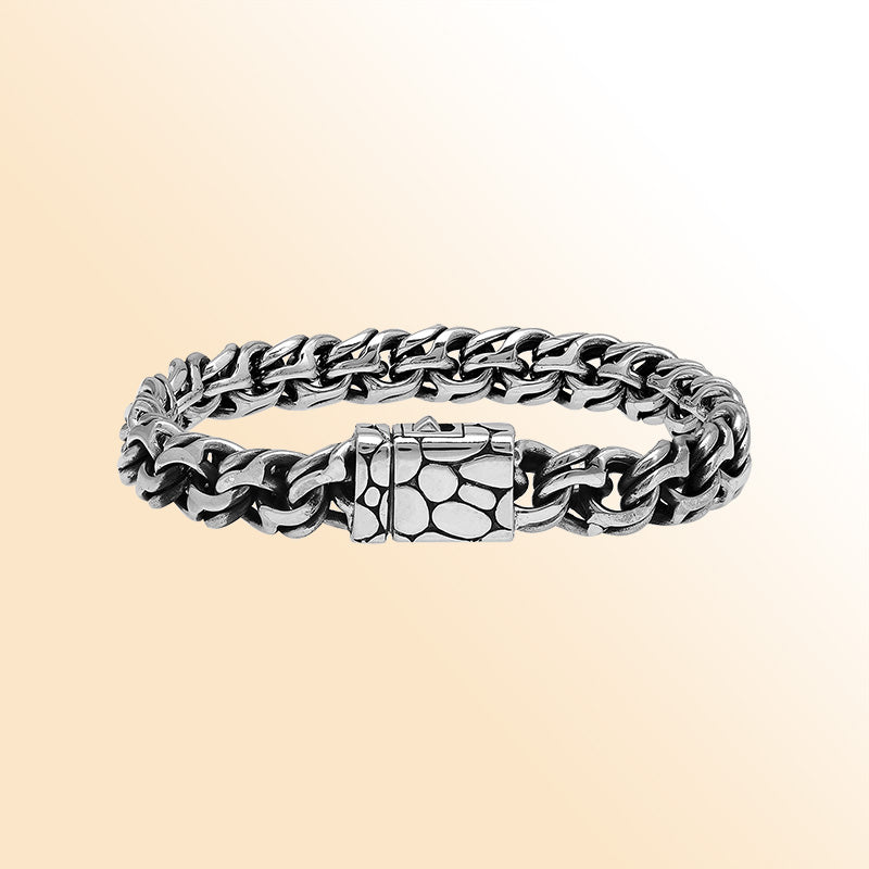 A handcrafted sterling silver rugged woven bracelet featuring a textured push clasp, polished and oxidized detailing, and bold masculine styling perfect for everyday wear.